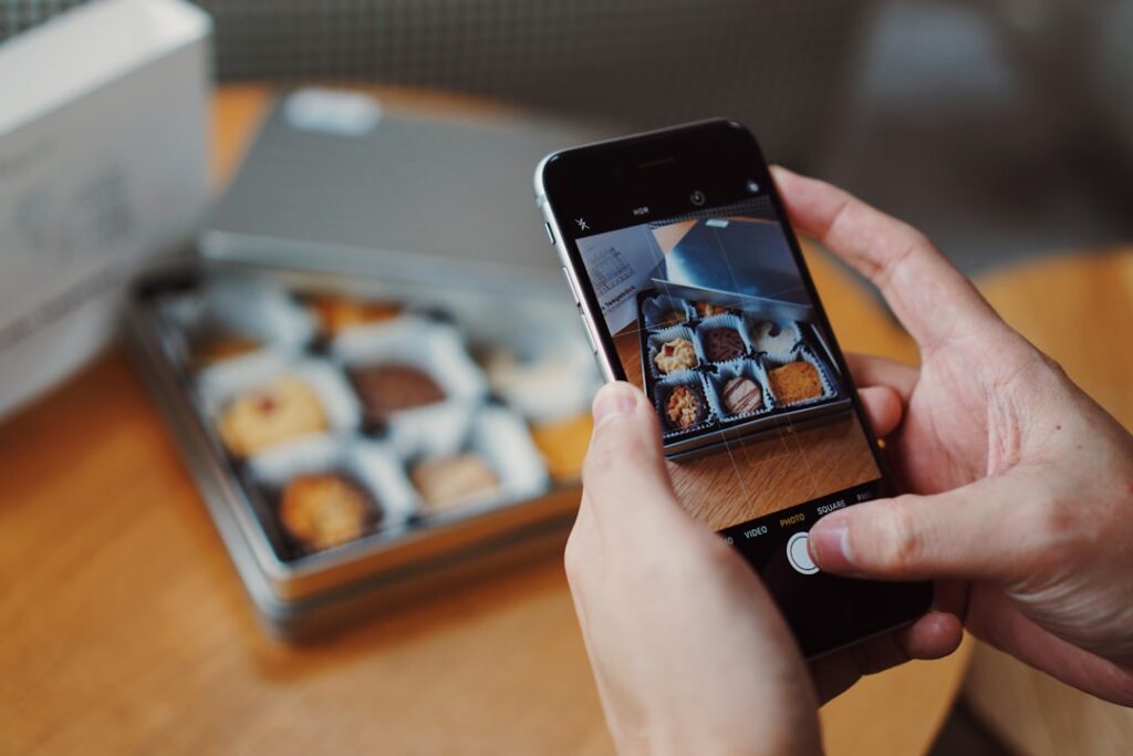 Hands photographing a product with a smartphone to create an online classified ad listing