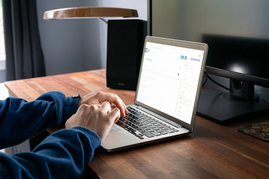 Person typing on a laptop to fill out an online registration or account creation form